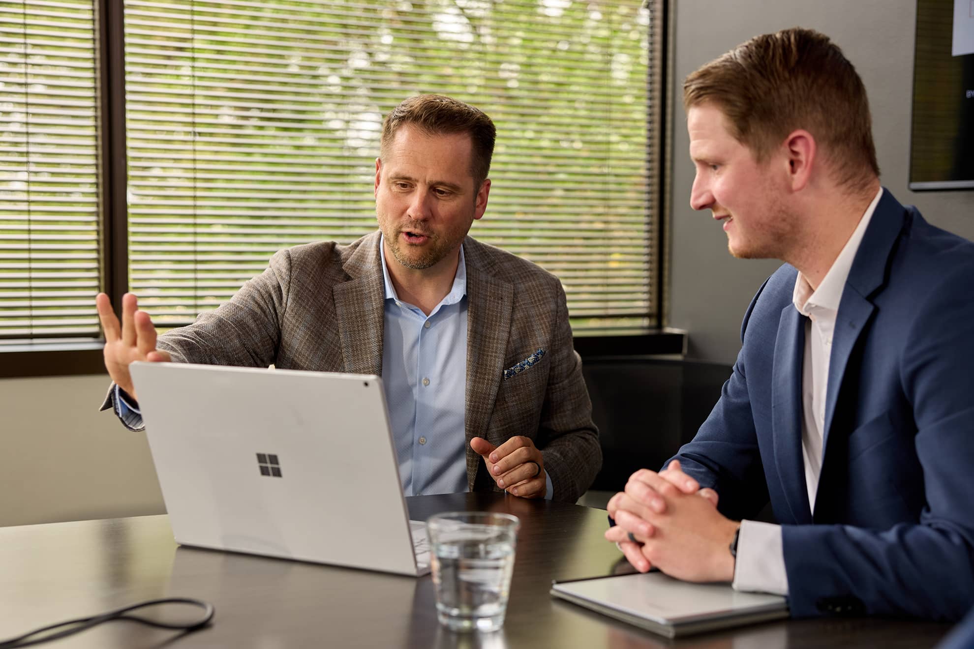 Two iTValuations Team Members Looking at Computer